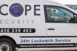 Scope Security locksmith van driving on road